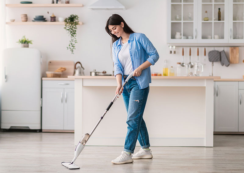 Woman vinyl floor cleaning | Country Carpet & Furniture