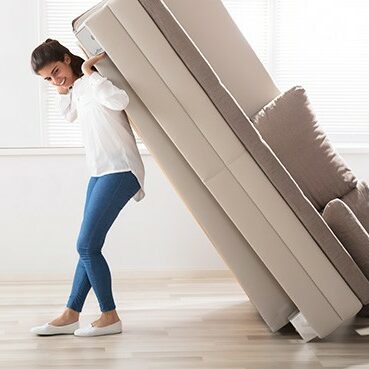 Woman moving sofa | Country Carpet & Furniture
